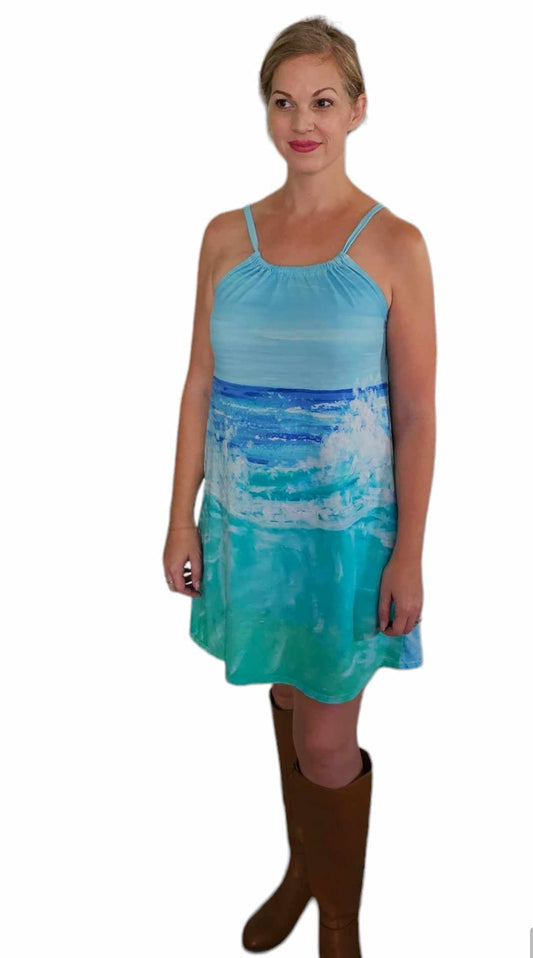 A woman wearing a cotton resort wear dress with a blue wave design