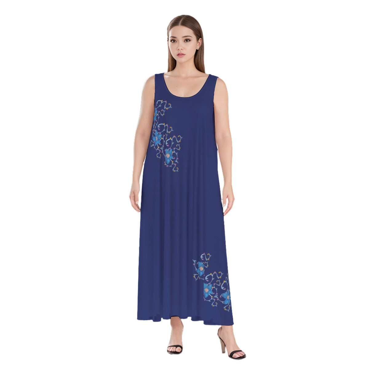 A woman wearing a dark blue beach and vacation dress with accent flowers, it is a flowing loose boho maxi dress that is lightweight