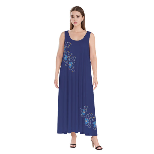 A woman wearing a dark blue beach and vacation dress with accent flowers, it is a flowing loose boho maxi dress that is lightweight