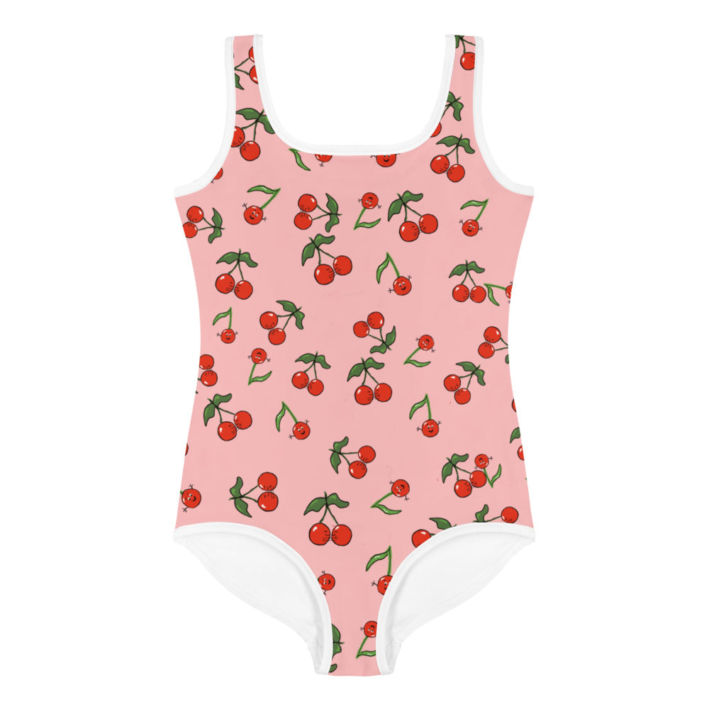 A girls swimsuit with cherries it is a one piece pink swimsuit with red cherries hugging and waving with green leaves